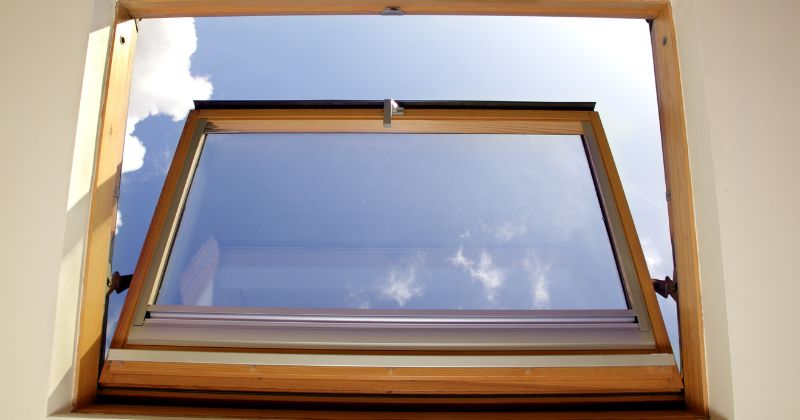A Bottom Hung or Hopper Casement Window installed on a house in a compact attic room