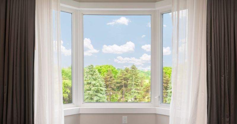 Installed fixed casement window on a house with a scenic view and a blue sky