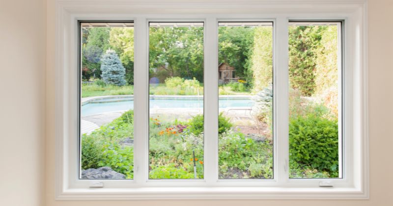 A Flush Casement Window installed on a house with a relaxing greenery backyard view