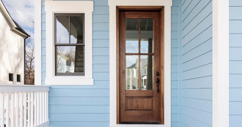 Wooden door frames against blue-painted walls.