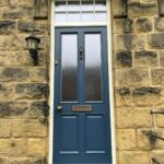 Accoya timber front door painted blue with antique brass door fittings