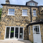 Yellow stone house in Leeds with new sliding sash windows by Patchett Joinery a bifold door and timber entrance door