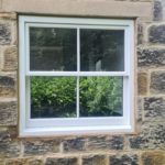 A brand new double glazed timber sliding sash window, finished in white by Patchett Joinery.